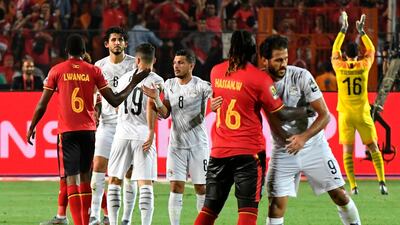 Players greet each other after the 2019 Africa Cup of Nations Group A match between Uganda and Egypt at the Cairo International Stadium. Egypt won the match 2-0 but both teams advanced to the last 16. AFP