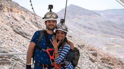 Adrian Mackay, 30, from India, rode the zipline at the weekend before getting down on one knee as Susan Kuruvilla, also from India, came into land on the 80m-high suspended platform on Jebel Jais, the UAE’s tallest mountain. She said yes. Photo / Supplied