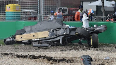 McLaren driver Fernando Alonso of Spain emerges from the wreck of his car after he collided with Haas driver Esteban Gutierrez of Mexico during the Australian Grand Prix at Albert Park in Melbourne, Australia, Sunday, March 20, 2016. (AP Photo/Theo Karanikos)