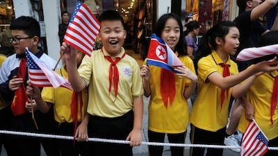 Bystanders wait for the motorcade of Donald Trump in Hanoi. Reuters