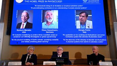 The winners of the 2021 Nobel Prize in Physics are displayed on a screen in Stockholm, Sweden. Photo: AFP