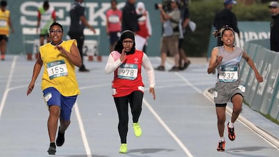 UAE sprinter Reem Alblooshi, centre, in the 100m at the Special Olympic Games, Dubai Police Stadium Pawan Singh / The National