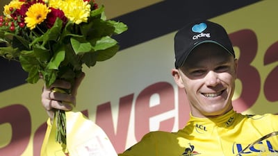 Britain's Chris Froome, wearing the overall leader's yellow jersey, celebrates on the podium after Stage 18 of the Tour de France. Peter Dejong / AP Photo