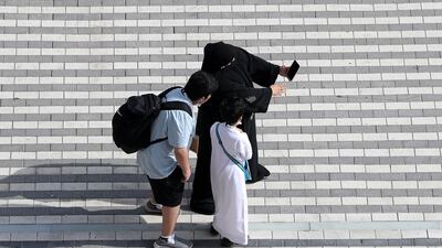 Visitors taking selfies to record their presence on the final day of Expo 2020 Dubai. Pawan Singh / The National