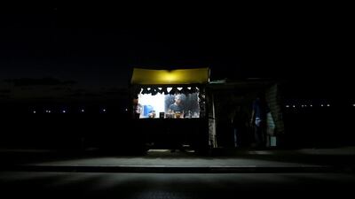 A Palestinian man sells coffee and tea along a street by the beach during a power outage in the northern Gaza. Mohammed Saber / EPA