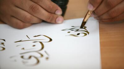 Artist pens some Arabic calligraphy. Randi Sokoloff / The National