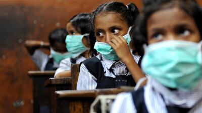 Indian pupils wearing protective masks in a classroom in Mumbai. AFP