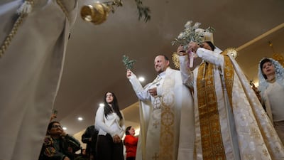 A Christian Syriac Orthodox priest leads a Palm Sunday service at the Queen of Peace Church in Arbil, the capital of the autonomous Kurdish region of northern Iraq. AFP