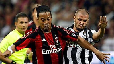 Juventus' Simone Pepe, right, fights for the ball with Ronaldinho during the pre-season Berlusconi Trophy match at the San Siro on August 22.