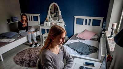Anni (R) and her sister Leni spend time in their room. AP Photo