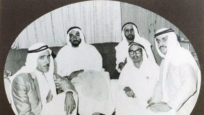 The men graduated in 1969 with degrees in agricultural engineering and returned to Abu Dhabi, where they were congratulated by Sheikh Zayed, seen here with his adviser Thani bin Morshid Al Romaithi (back right), in their project office on Saadiyat Island. Front row from left, Mohammed Mjrin Al Romaithi. Hamad Al Mazrouie and Abdullah Kaddas Al Romaithi. Courtesy Ali Kaddas Al Romaithi