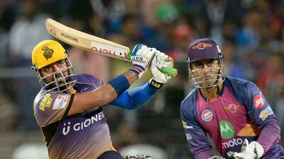 Kolkata Knight Riders' Robin Uthappa, left, plays a shot as Rising Pune Supergiant's MS Dhoni watches during their Indian Premier League match at The Maharashtra Cricket Association Stadium in Pune on April 26, 2017. Punit Paranipe / AFP