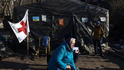 Tetyana and other residents wait in Kyiv, after being relocated from Irpin town. EPA