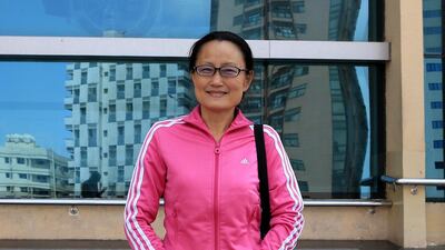 Tu Jing, a nurse from China, talks about their financial concerns from living in Abu Dhabi. Ravindranath K / The National