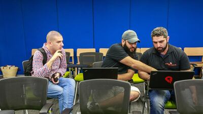 From left: Event mentor Mohamed Mehanna, Ahmed AbuSaad and Abdulhadi Hafez at the Dubai Startup Weekend at Astrolabs Dubai. Victor Besa for The National