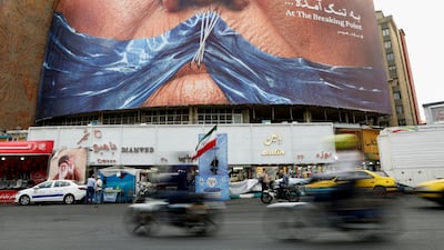 In Tehran, an anti-US billboard shows President Donald Trump and the Strait of Hormuz. Reuters