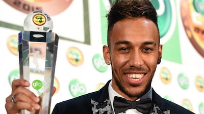 Gabonese striker Pierre-Emerick Aubameyang poses with the African Footballer of the Year Award during 2015 Glo-CAF Awards in Abuja, on December 7, 2016. AFP PHOTO/PIUS UTOMI EKPEI