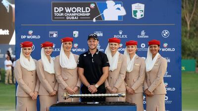 Danny Willett of England poses with the DP World Tour trophy with the Emirates cabin crew following the final round of the DP World Tour Championship at Jumeirah Golf Estates in Dubai, United Arab Emirates. Getty Images