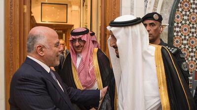 King Salman bin Abdulaziz Al Saud, right, and Iraq's prime minister Haider Al Abbadi, greet each other in Riyadh on the first stop of Mr Abadi's three-day tour of the Arabian Gulf. Saudi Press Agency / EPA