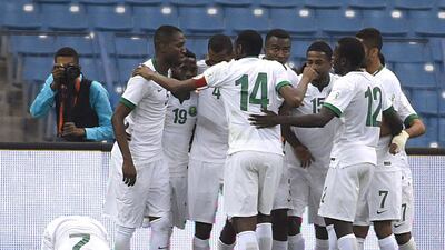 Saudi footballer Saeed Al Mowalad (L) kisses the ground as teammates celebrate a goal during the Saudi Arabia vs Qatar 22nd Gulf Cup football tournament match at King Fahad stadium in Riyadh on November 13, 2014. AFP PHOTO/ FAYEZ NURELDINE
