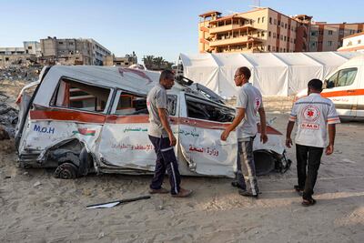 Palestinian paramedics inspect a destroyed ambulance in Khan Younis, the Gaza Strip, on July 16, 2024. AFP