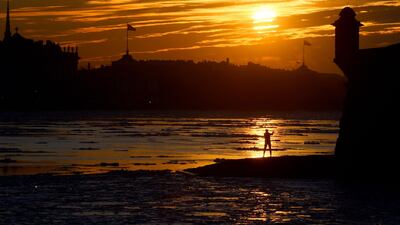 A winter swimming enthusiast is seen after taking a swim in the partially frozen Neva river at sunset in central Saint Petersburg. AFP