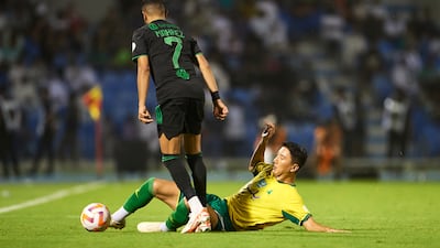 Al Khaleej's Jung Woo-Young attempts to tackle Al Ahli forward Riyad Mahrez. Getty