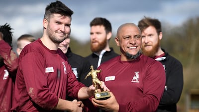 Roberto Carlos presents the man-of-the-match award to Callum Bebb. AFP