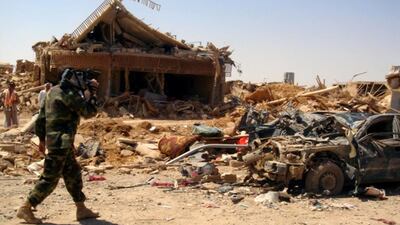 An Iraqi soldier records the aftermath of a suicide attack near Mosul. Mohammed Ibrahim / AP Photo