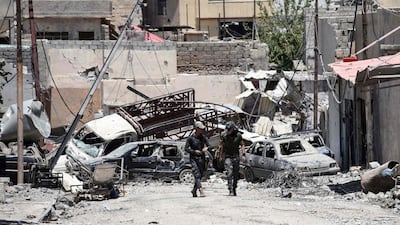 Iraqi soldiers walk down a street in Mosul's western Al-Shifa district on June 15, 2017, during the ongoing offensive to retake the city from ISIL. Mohamed El Shahed / AFP