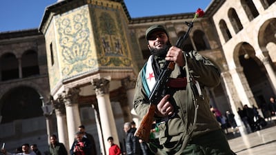 A HTS rebel fighter at the Umayyad Mosque in Damascus. AFP
