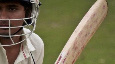 In this May 12, 2014 photo, John Adams High School batsman Tazul Uddin raises his bat during a warm-up before playing against Midwood High School in a match between New York City public schools as participation in cricket grows in the US thanks to America's large immigrant populations. Bebeto Matthews / AP