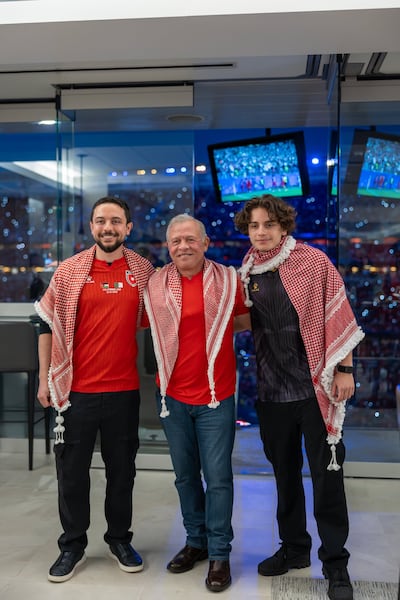 King Abdullah II with Crown Prince Hussein, left, and Prince Hashem during Jordan's World Cup match against Algeria. Photo: Petra