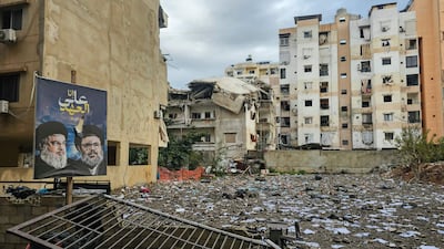 A banner bearing portraits of slain Hezbollah leaders Hassan Nasrallah, left, and Hashem Safieddine at the site of a strike on Burj Al Barajneh, in Beirut's southern suburbs. AFP
