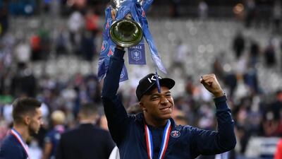 Kylian Mbappe celebrates with the trophy. AFP