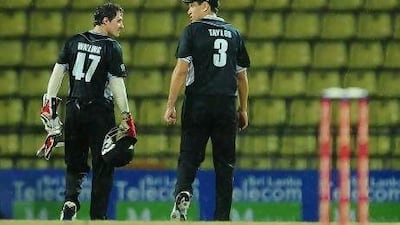 Denied by rain, Ross Taylor, right, and John Watling leave the field disappointed.