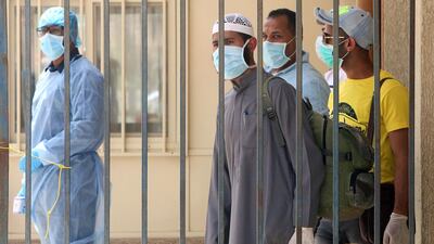 Egyptians at a centre in Kuwait for residency offenders wishing to avail of an amnesty announced amid the coronovirus crisis, in Kuwait City on April 6, 2020. AFP