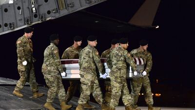 US soldiers carry team the remains of staff sergeant Dustin Wright at Dover Air Force Base in Delaware on October 5, 2017. He was one of four US troops and four Niger forces killed in an ambush by ISIL-linked militants in Niger. Staff Sgt Aaron J Jenne / US Air Force via AP
