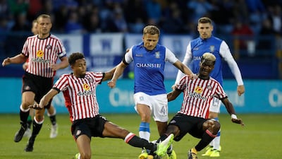 Sheffield Wednesday's Almen Abdi battles for the ball with Sunderland's Brendan Galloway, left, and Didier Ibrahim Ndong, right, during the Championship match at Hillsborough. Martin Rickett / Press Association