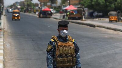A member of the Iraqi security forces stands guard at a checkpoint, enforcing a curfew due to the COVID-19 coronavirus pandemic, in Baghdad's eastern Sadr City suburb on May 31, 2020. AFP