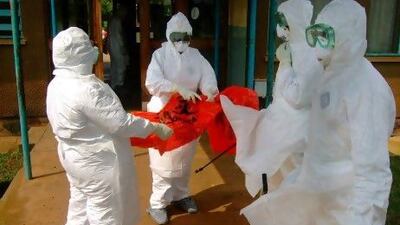 World Health Organization staff wear protective clothing as they prepare to enter Kagadi Hospital, about 200 kilometres from Kampala, where an outbreak of Ebola virus started.