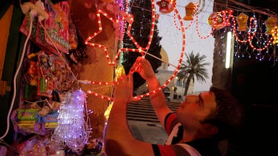 July 31, 2011, Jerusalem. A Palestinian vendor hangs decorations for the upcoming holy month of Ramadan at a market in Jerusalem's Old City. REUTERS/Ammar Awad