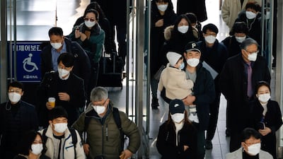 People walk at a railway station in Seoul, South Korea. Reuters