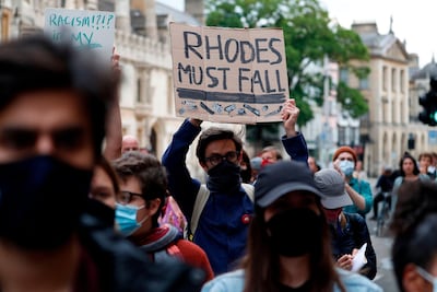 A demonstration by the Rhodes Must Fall campaign calling for the removal of the statue of British imperialist Cecil John Rhodes outside Oriel College, at the University of Oxford, June 9. Adrian Dennis / AFP