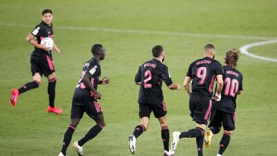 Real's Karim Benzema of Real Madrid celebrates with teammates after Emerson's own goal. Getty