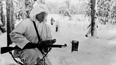 A Finnish radio reporter with a gun and a microphone during coverage on the front line of the 1939-1940 Winter War. Getty Images