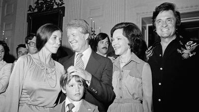 The president and his wife chat with singer Johnny Cash and his family at the White House. Getty Images