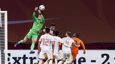 Netherlands keeper Marco Bizot leaps to punch the ball. EPA