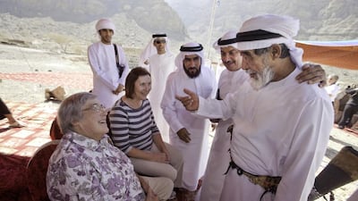 Ruth Ash, left, greets wadi emir Ali Rashed Al Hebsi, accompanied by her niece, Catherine Wilson, in 2013 during a welcoming ceremony for Ash at Wadi Qada’a. Jaime Puebla / The National