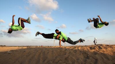 Palestinian youths practice their parkour skills at the Israel-Gaza border in the southern Gaza Strip. Said Khatib / AFP